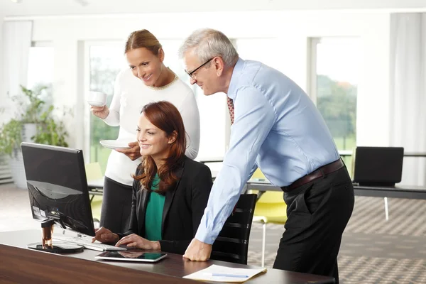 Équipe de vente travaillant sur ordinateur portable au bureau — Photo