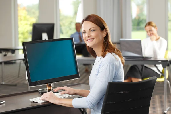 Businesswoman sitting at office — Stock Photo, Image