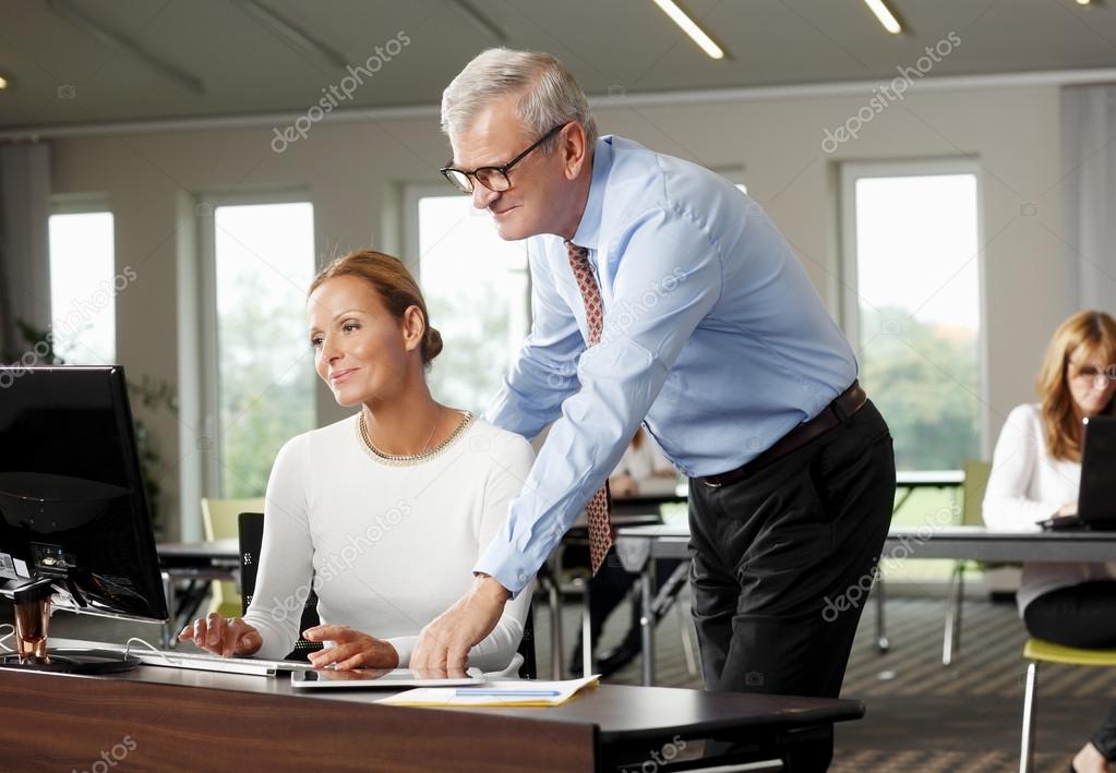 Businessman giving advise to sales woman