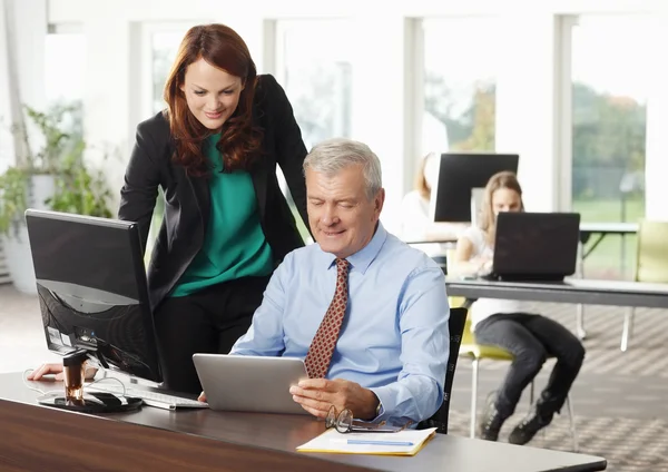 Business people with computer and tablet — Stock Photo, Image