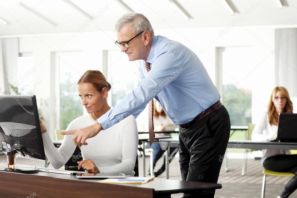 Businessman giving advise to sales woman