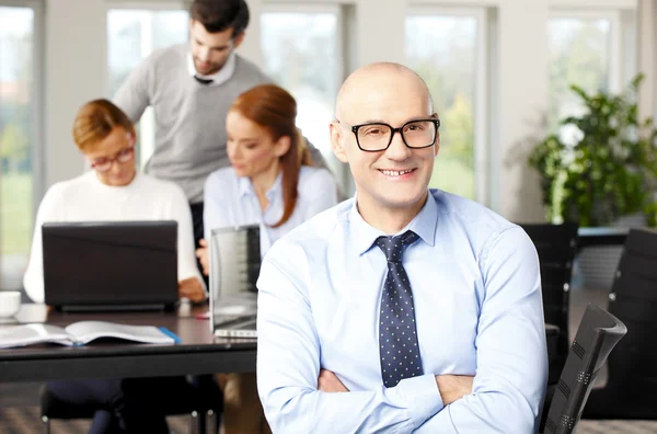 Confident businessman sitting at meeting — Stock Photo, Image