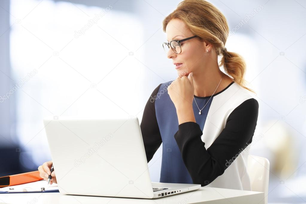 Businesswoman at office using laptop