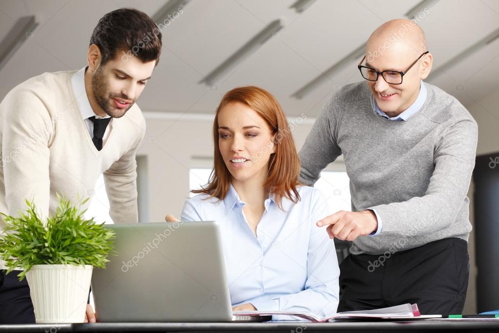 Sales team with computer at office