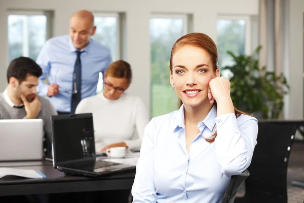 Sales woman sitting at office — Stock Photo, Image