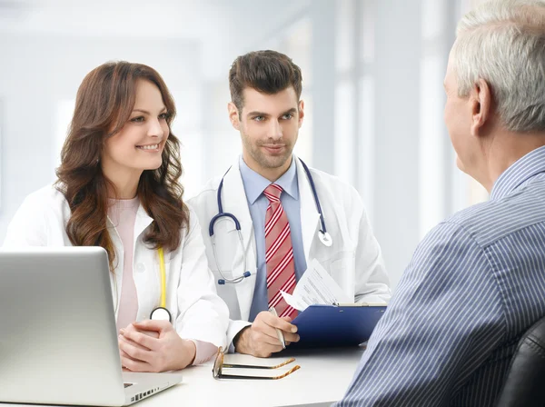 Medical team with elderly patient — Stock Photo, Image