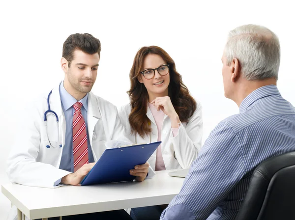 Medical team with elderly patient. — Stock Photo, Image