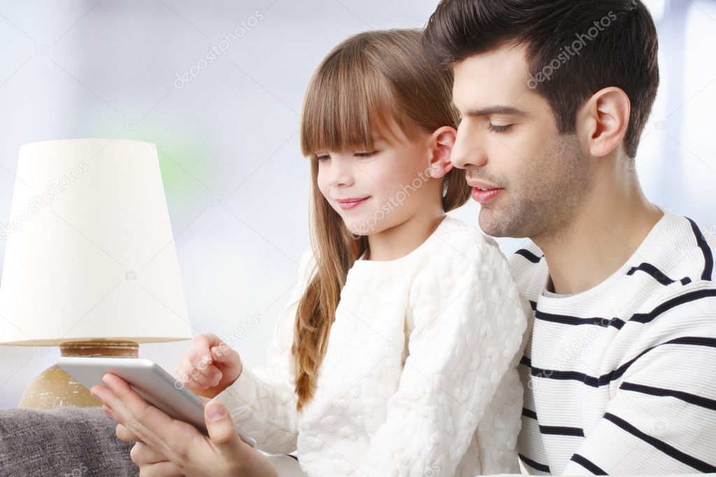 Girl and father with tablet