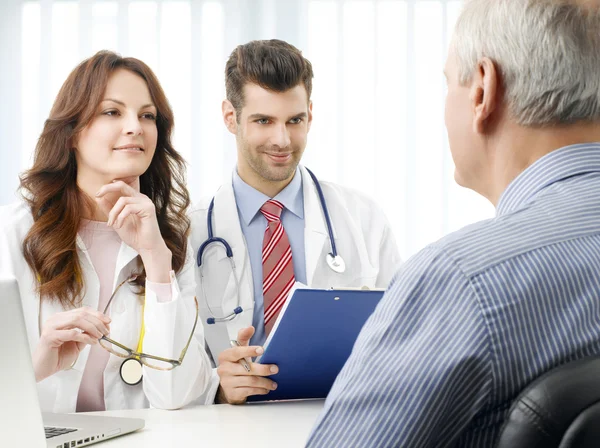 Medical team with elderly patient — Stock Photo, Image