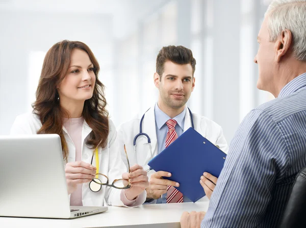 Medical team with elderly patient — Stock Photo, Image