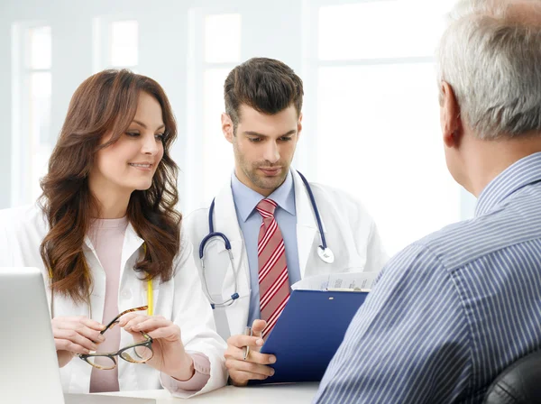 Medical team with elderly patient — Stock Photo, Image