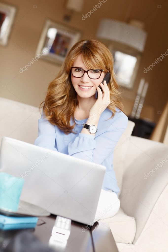 Woman with laptop making call