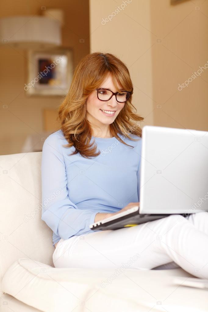 Woman writing blog at laptop