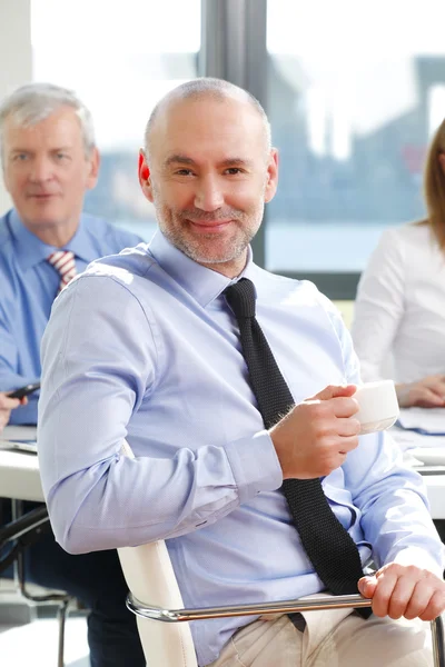 Businessman sitting at meeting — Stock Photo, Image