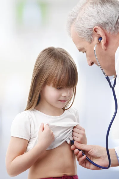 Doctor examining child at medical center Stock Photo