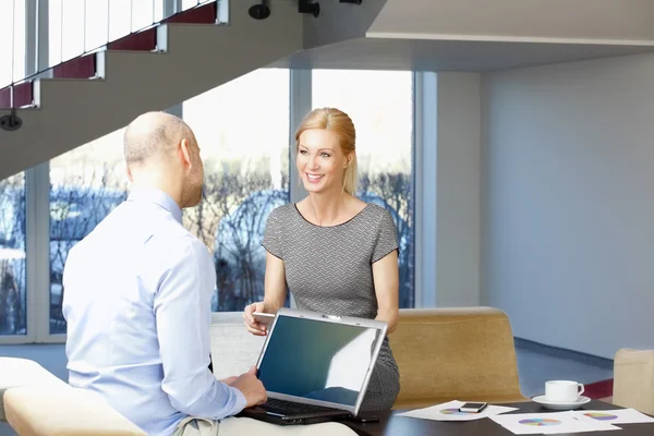 Businessman interviewing businesswoman at office — Stock Photo, Image