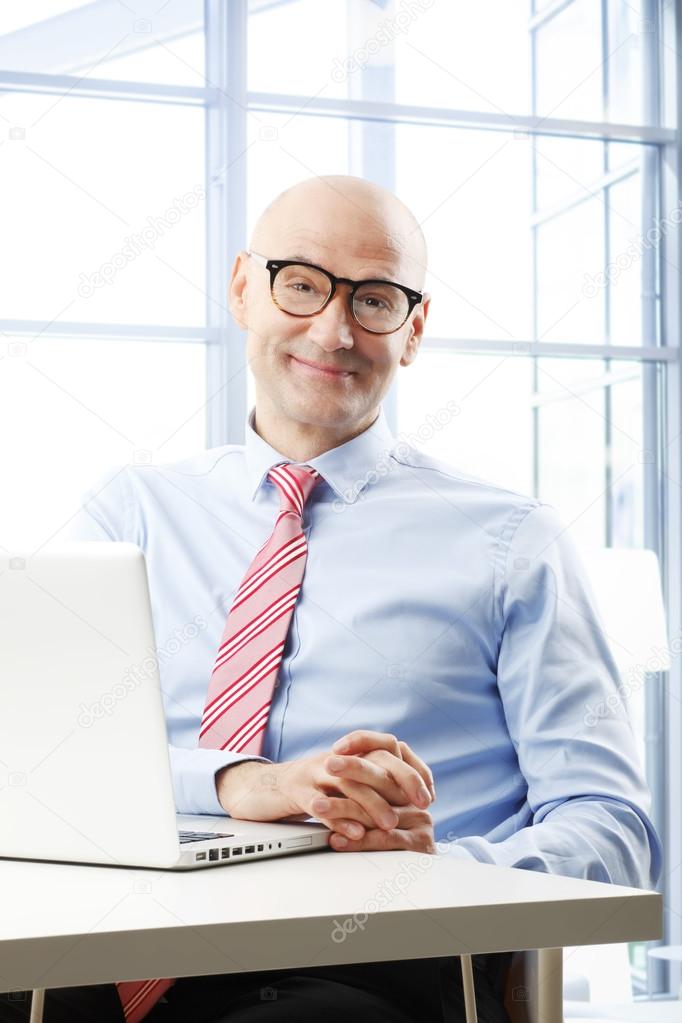 Businessman sitting in front of laptop