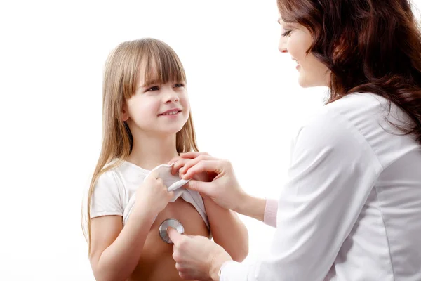 Doctor listening the heart break of girl — стоковое фото