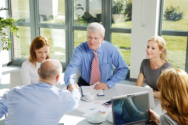 Business team sitting around conference table
