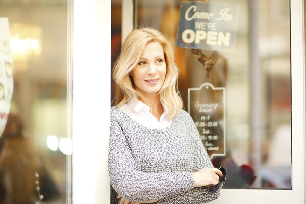 female owner standing with arms crossed