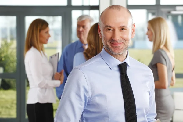 Senior businessman standing at office — Stock Photo, Image