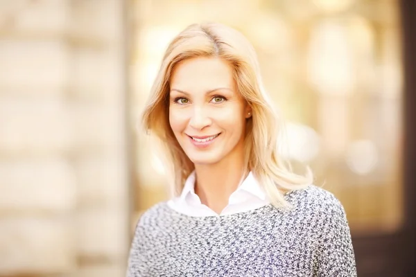 Woman looking at camera and smiling — Stock Photo, Image