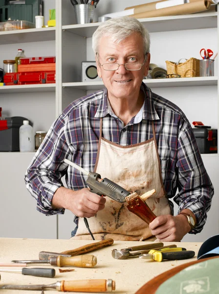 Carpenter sitting at his workshop — Stockfoto