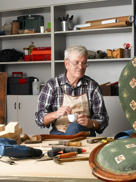 Carpenter sitting at his workshop — Stockfoto