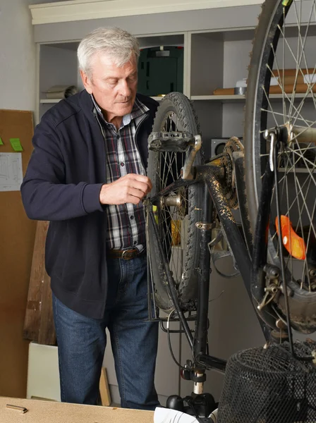 Retired bicycle repair man — Stock Photo, Image