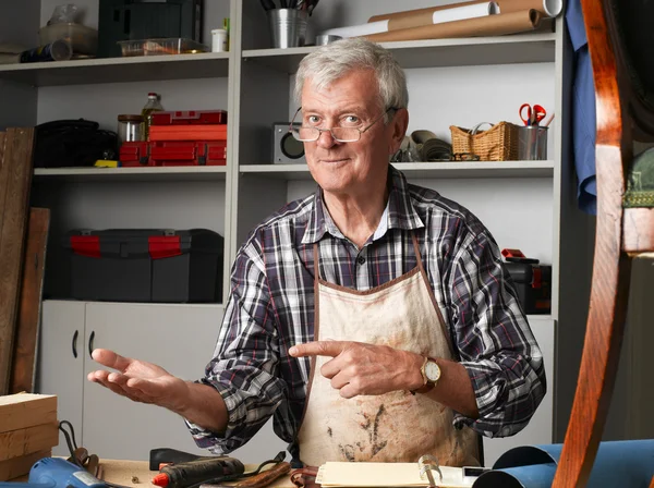 Carpenter sitting in his workshop — Stock Photo, Image