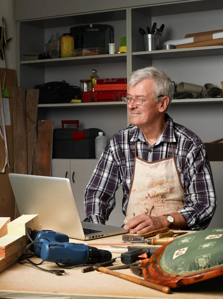Carpenter sitting at his workshop — Stok fotoğraf