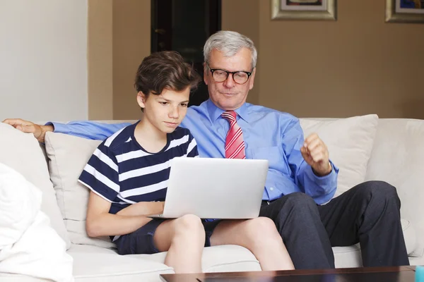 Grandfather and boy playing online — 스톡 사진