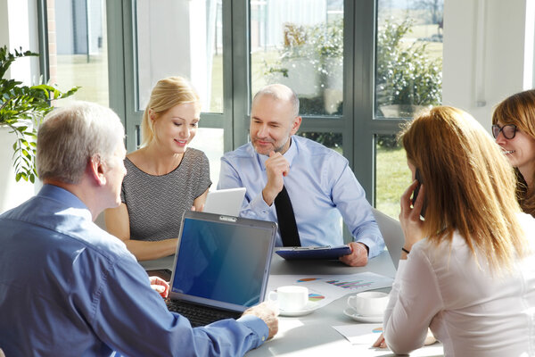 business team sitting around at conference table