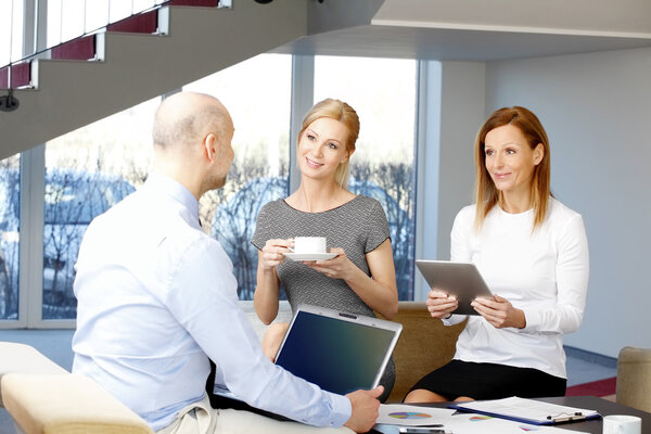 businessman sitting with businesswomen at office