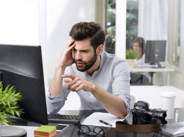 young magazine editor in front of monitor
