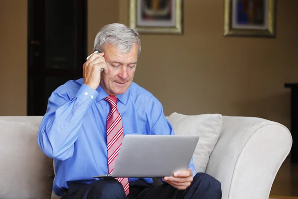 Retired man sitting at home — Stock Photo, Image