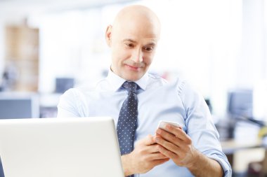 senior bank employee in front of computer