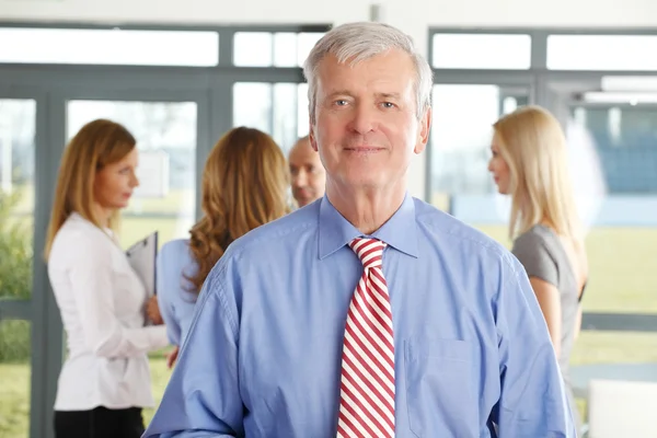 Senior businessman standing at office — Stock Photo, Image