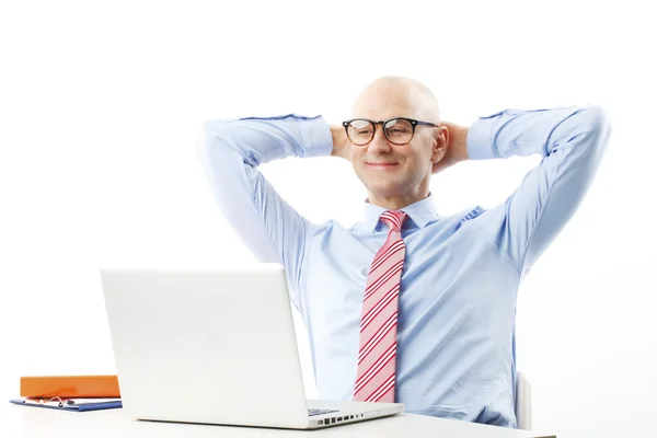 Senior businessman in front of laptop — Stockfoto