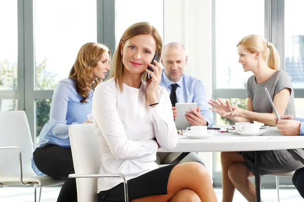 Executive businesswoman sitting at office — Stock Photo, Image