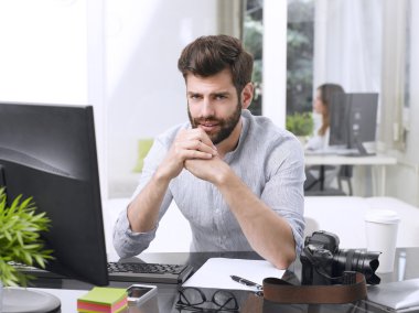 worried young graphic studio owner