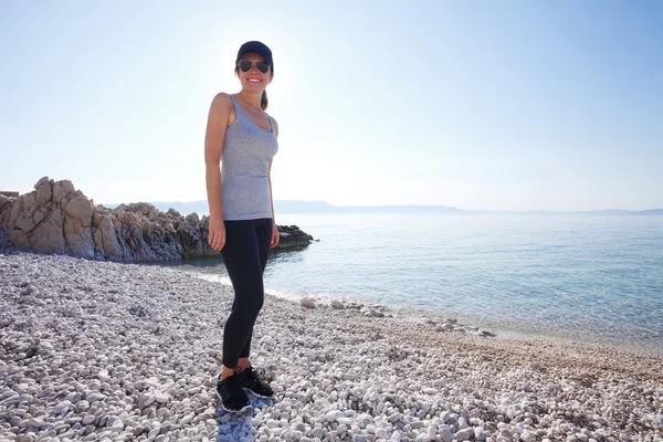 Woman on beach after morning run — Stock Photo, Image