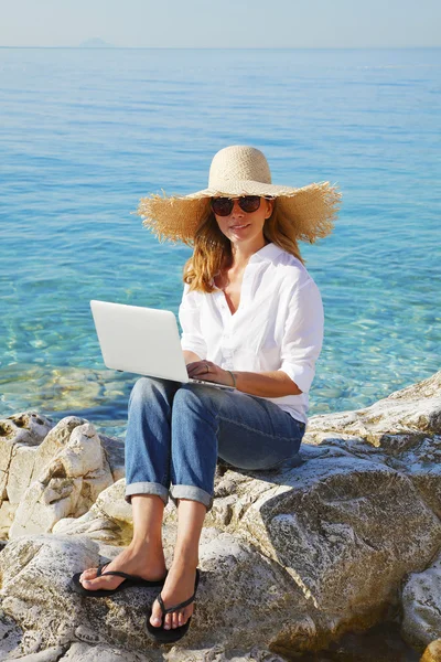 Femme occasionnelle travaillant au bord de la mer — Photo