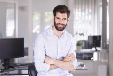 assitant with arms crossed standing at office