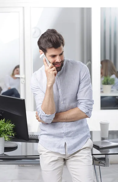 Professional man standing at desk — Stok fotoğraf