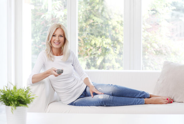 woman smiling while sitting at home