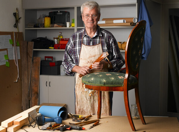 retired man standing at workshop