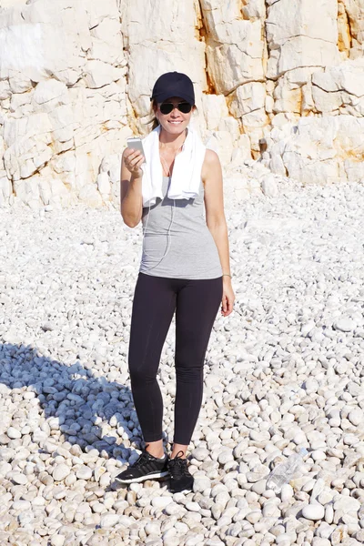 Woman on beach after morning running — Stock Photo, Image