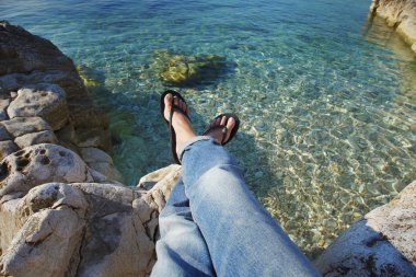 woman with bared feet relaxing at beach