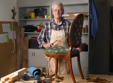 retired man standing at his workshop